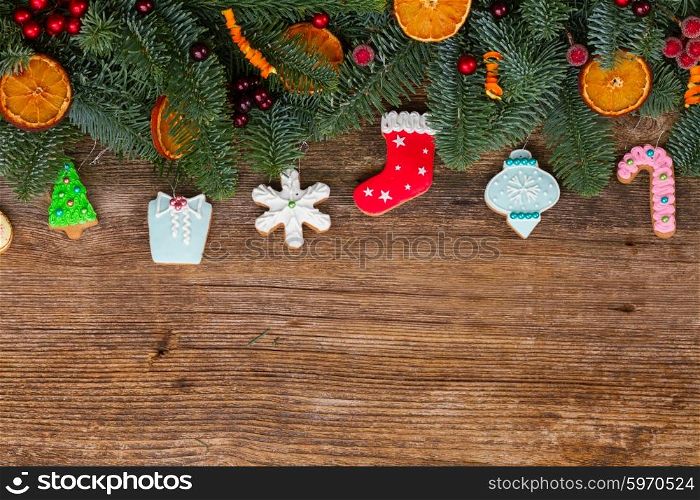 christmas gingerbread cookies. christmas gingerbread cookies with fir tree border on wooden background