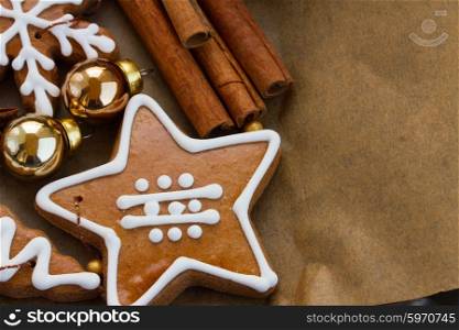 christmas gingerbread cookies. christmas gingerbread star cookies and decorations on cooking paper with copy space