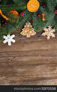 christmas gingerbread cookies with fir tree border close up, copy space on wooden background