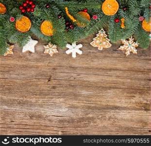 christmas gingerbread cookies with fir tree border, copy space on wooden background
