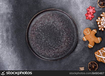 Christmas gingerbread. Delicious gingerbread cookies with honey, ginger and cinnamon. Christmas homemade gingerbread cookies on a dark concrete table