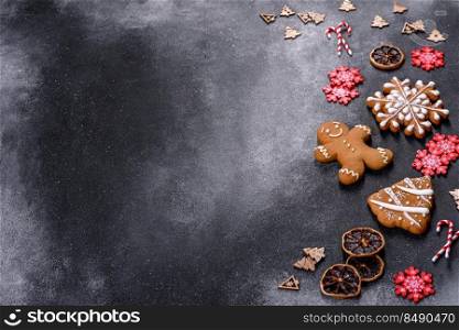 Christmas gingerbread. Delicious gingerbread cookies with honey, ginger and cinnamon. Christmas homemade gingerbread cookies on a dark concrete table