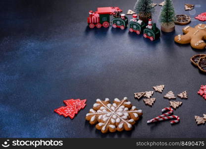 Christmas gingerbread. Delicious gingerbread cookies with honey, ginger and cinnamon. Christmas homemade gingerbread cookies on a dark concrete table