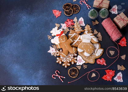 Christmas gingerbread. Delicious gingerbread cookies with honey, ginger and cinnamon. Winter composition. Christmas homemade gingerbread cookies on dark concrete table