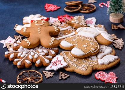 Christmas gingerbread. Delicious gingerbread cookies with honey, ginger and cinnamon. Winter composition. Christmas homemade gingerbread cookies on dark concrete table