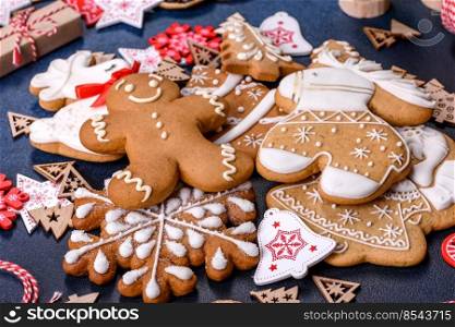 Christmas gingerbread. Delicious gingerbread cookies with honey, ginger and cinnamon. Winter composition. Christmas homemade gingerbread cookies on dark concrete table