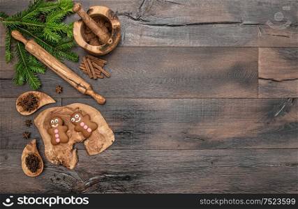 Christmas gingerbread man cookies, spices and baking tools. Holidays food background