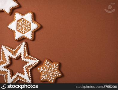 Christmas gingerbread stars on brown paper background. Top view
