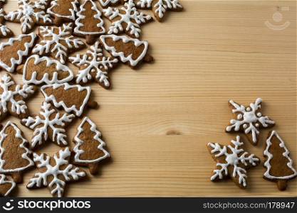 Christmas gingerbread with icing on a light wooden background, copyspace
