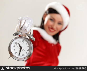 christmas girl in santa hat. excited girl with santa hat holding clock. illustration