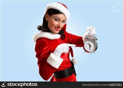 christmas girl in santa hat. excited girl with santa hat holding clock. illustration