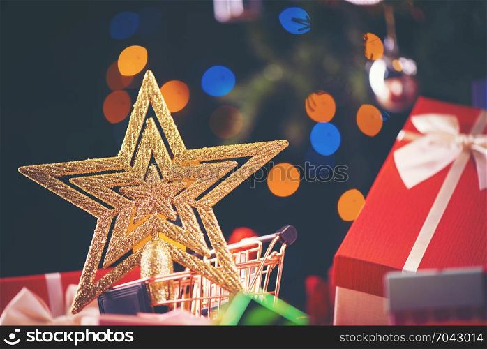 Christmas gold star against background of blurred lights