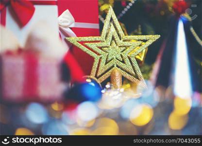 Christmas gold star against background of blurred lights