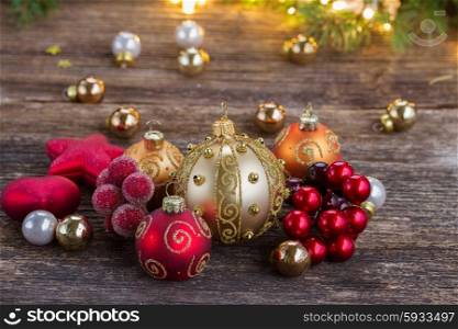 christmas golden and red decorations with lights in background. christmas decorations with gift box
