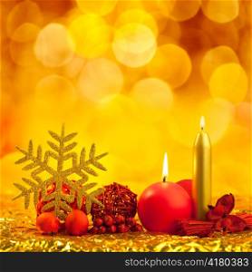 christmas golden snowflake with red candles on bokeh lights background