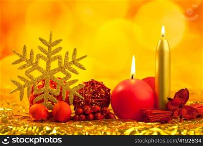 christmas golden snowflake with red candles on bokeh lights background