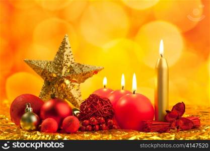christmas golden star with red candles on bokeh lights background