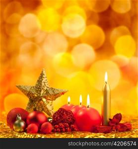 christmas golden star with red candles on bokeh lights background