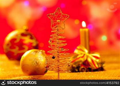 Christmas golden tree with babubles and candles in blur lights