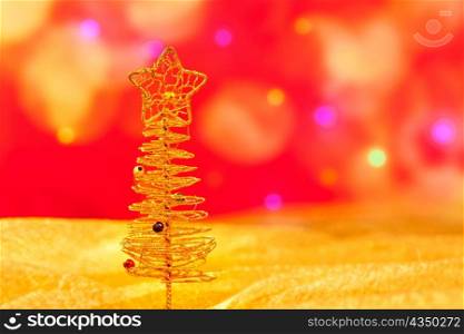 Christmas golden wire tree in blurred lights background