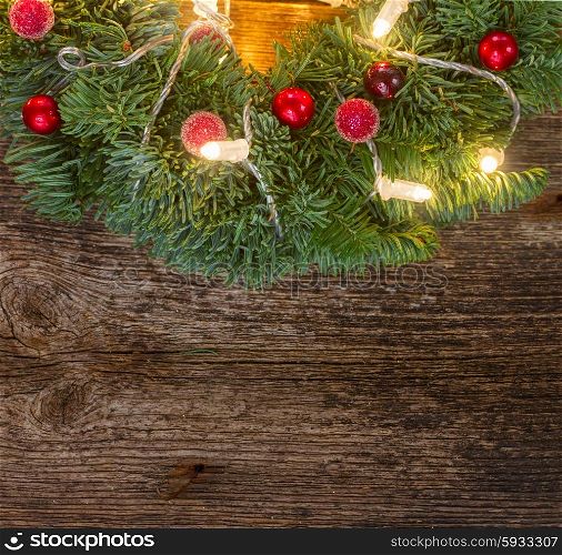 christmas green wreath with lights, copy space on wooden table