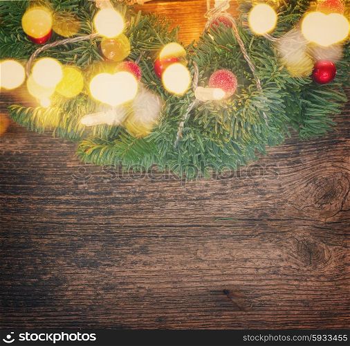 christmas green wreath with lights, copy space on wooden table , retro toned