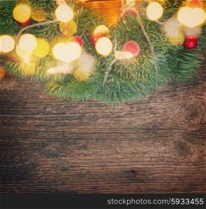 christmas green wreath with lights, copy space on wooden table , retro toned
