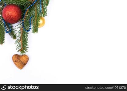 Christmas greeting card. Fir with balls and heart on white background and copy space