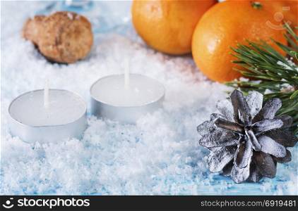 Christmas greeting card. Oranges, cone. Ornamental card oranges, candles and bumps