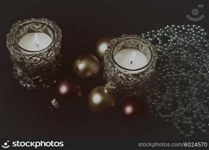 Christmas greeting card with candles and Christmas decorations on a black background
