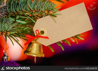 Christmas greeting with a bell hanging on a tree