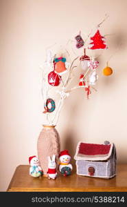 Christmas handmade decor on the branches over wall