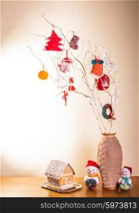 Christmas handmade decor on the branches over wall. Christmas handmade decor
