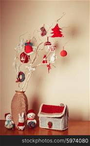 Christmas handmade decor on the branches over wall. Christmas handmade decor