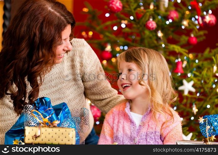 Christmas - happy family (mother with daughter) with gifts on Xmas Eve