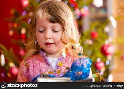 Christmas - happy little girl with Xmas present on Christmas Eve