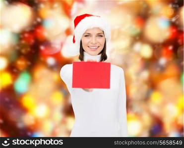 christmas, holdays, people, advertisement and sale concept - happy woman in santa helper hat with blank red card over red lights background