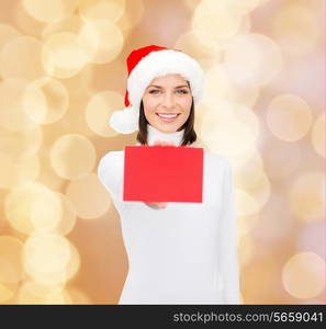 christmas, holdays, people, advertisement and sale concept - happy woman in santa helper hat with blank red card over beige lights background