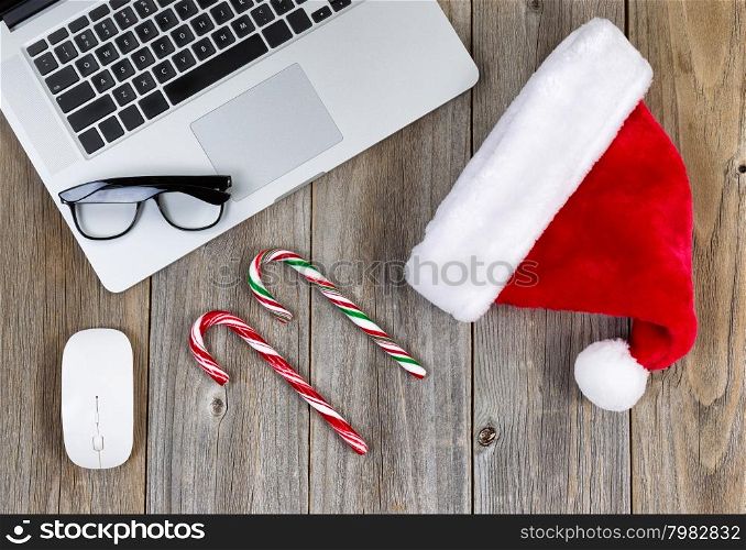 Christmas holiday and technology on rustic desktop. High angled view.