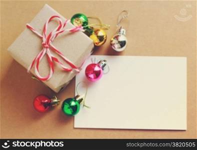 Christmas holiday background with blank greeting card and Christmas decorations, retro filter effect