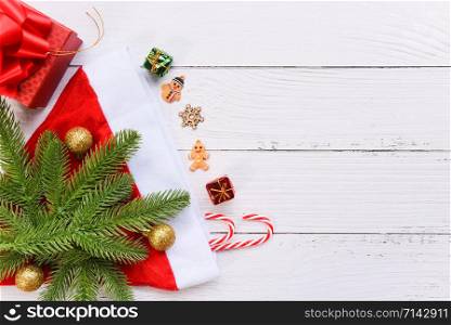 Christmas holiday background with Santa hat and fir branches decoration candy cane pine tree gift box and Festive Happy New Year object , top view copy space