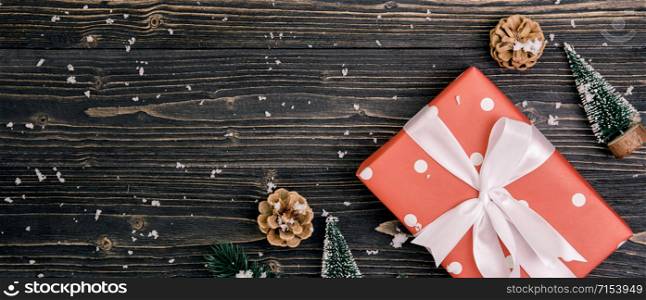 Christmas holiday composition with red gift box decoration on wooden background, new year and xmas or anniversary with presents on wood table in season, top view or flat lay, banner website.