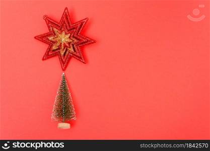 Christmas holiday theme with small Christmas trees and start decorated on red background. Merry Christmas concept. With Copy space for text