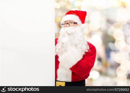 christmas, holidays, advertisement and people concept - man in costume of santa claus with white blank billboard making hush gesture over lights background