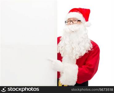 christmas, holidays, advertisement, gesture and people concept - man in costume of santa claus pointing finger to white blank billboard