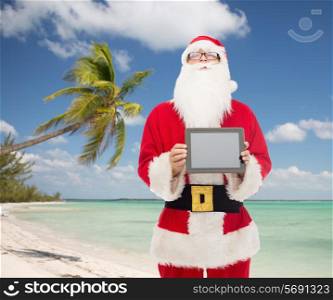 christmas holidays, advertisement, technology, travel and people concept - man in costume of santa claus with tablet pc computer showing blank screen over tropical beach background