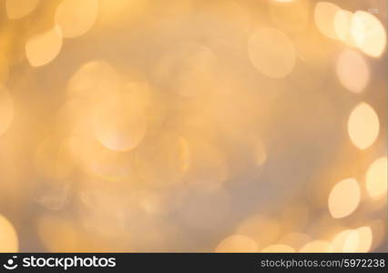 christmas, holidays and background concept - blurred beige holidays lights