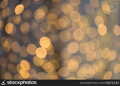 christmas, holidays and background concept - blurred golden lights bokeh