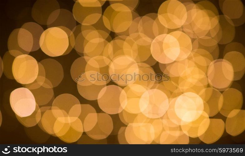 christmas, holidays and background concept - blurred golden lights bokeh