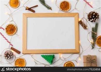 christmas, holidays and celebration concept - board, garland and decorations on white background. white board, garland and christmas decorations